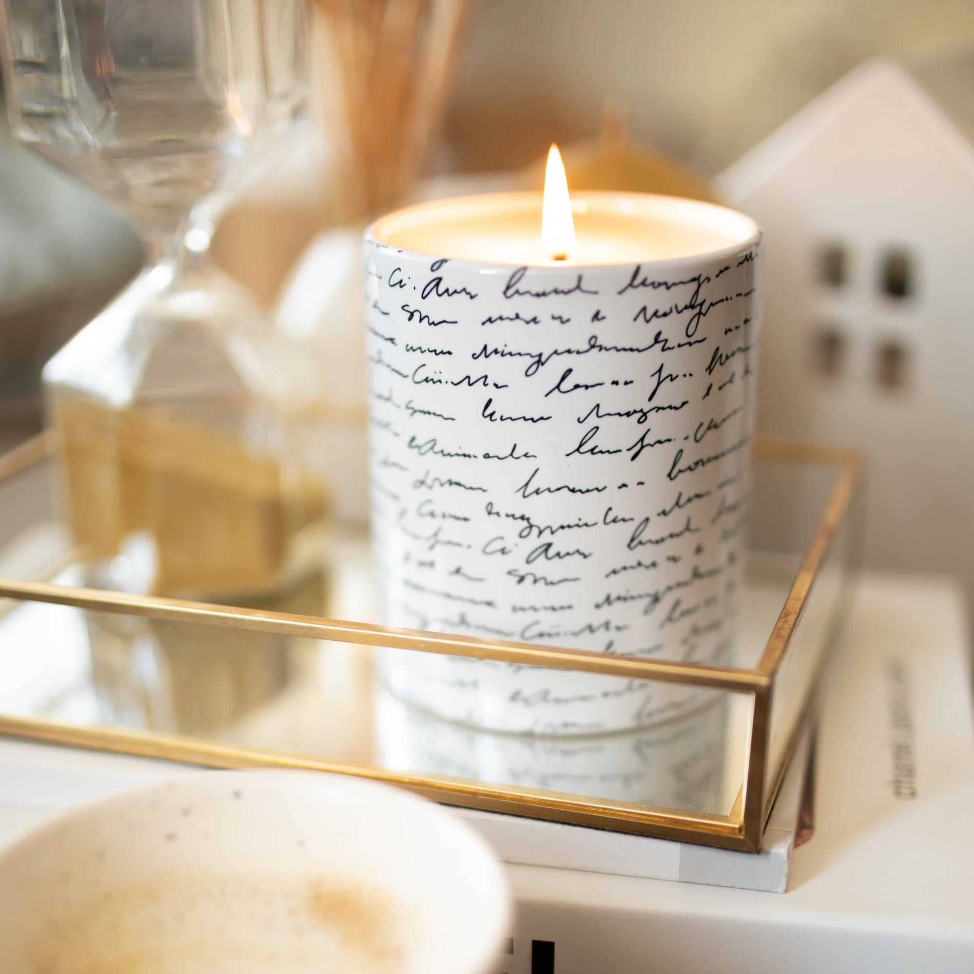 Scented Soy Wax One Wick Candle on Ceramic Vessel with Black and White Scribble Design on Decorated Table.